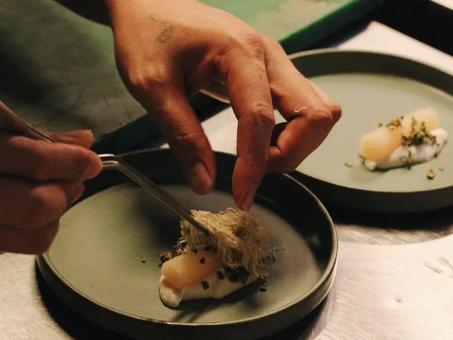 The kitchen plating a course