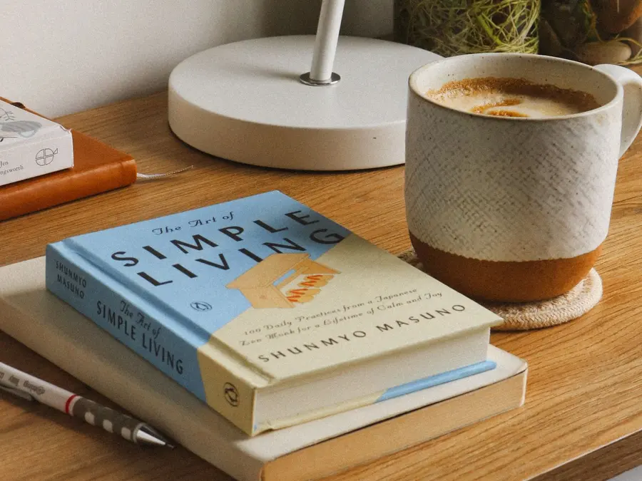 A cozy desk with coffee and books